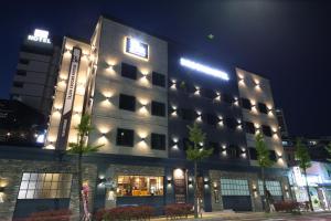 a large building with lights on it at night at Brooks Hotel Tongyeong in Tongyeong
