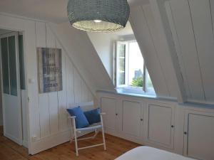 a room with a bed and a chair and a window at Country House in Porz Bilic near Sandy Beach in Locquirec