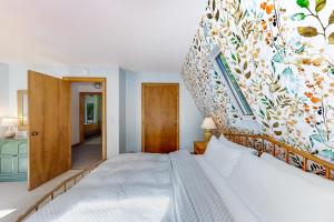 a bedroom with a large bed with a colorful wall at Pittsfield Paradise in Pittsfield
