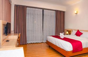 Letto o letti in una camera di Drishya Hotel