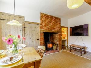 a dining room with a table and a fireplace at Angel Lane in Woodbridge