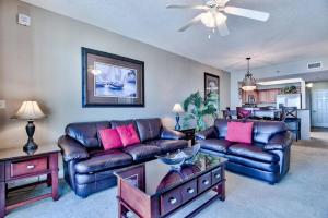 a living room with two leather couches and a table at Beautiful beach home for a perfect vacation in Destin
