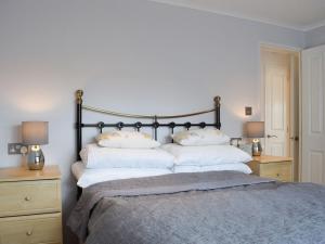 a bedroom with a bed with two pillows on it at Whinfell in Newton on the Moor