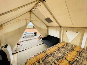 an overhead view of a tent with a bed and a couch at Desert Sage Retreat in Colorado City