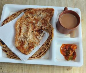 a plate of food with toast and a cup of coffee at Goroomgo Elite Stay Salt Lake Kolkata Near Metro Station in Kolkata