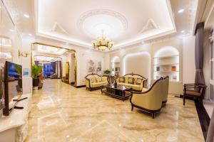 a living room filled with furniture and a chandelier at Wisteria Hotel in Da Lat