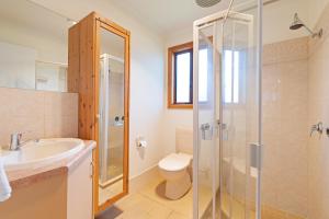 a bathroom with a shower and a sink and a toilet at Adelaide Caravan Park - Aspen Holiday Parks in Adelaide