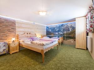 a bedroom with two beds and a mural of a mountain at Wesoła Chatka - Krupówki 37a -CENTRUM in Zakopane