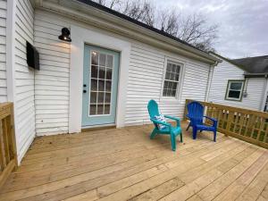 two blue chairs sitting on a wooden deck at Richmond Cottage! 3 BR House in the Heart of RVA in Richmond