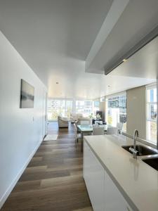 a kitchen with a sink and a counter top at Docklands Luxury Penthouse Right Above The District Docklands in Melbourne