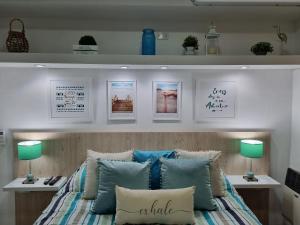 a bedroom with a bed with blue and white pillows at Departamento Vera Mujica 3 cochera propia incluida in Rosario
