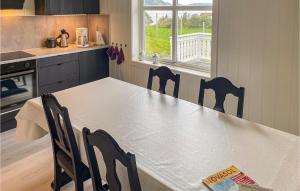 a kitchen with a table and chairs in a kitchen at Cozy Home In Etne With Wifi in Etnesjøen