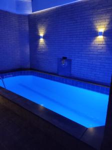 a large swimming pool with blue lighting in a room at Champion motel in Rio de Janeiro