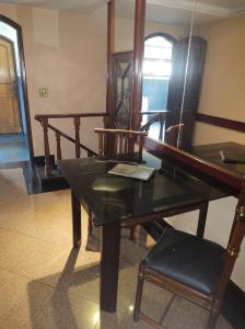 a wooden table with a mirror and a chair at Champion motel in Rio de Janeiro