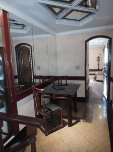 a dining room with a table and a mirror at Champion motel in Rio de Janeiro
