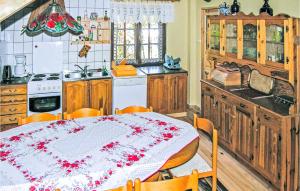 a kitchen with a table with a table cloth on it at 3 Bedroom Stunning Home In Grunwald in Mielno