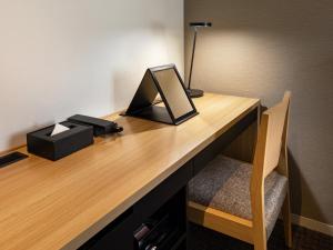 a desk with a mirror and a lamp on it at Best Western Hotel Fino Tokyo Akihabara in Tokyo