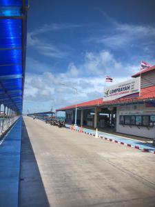 an empty pier with a gas station on the water at Coffeeisland in Nathon