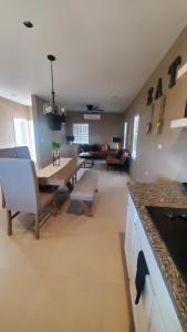 a kitchen and living room with a table and chairs at Sofia apartment in Puerto Peñasco