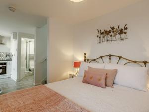 a bedroom with a large white bed with pink pillows at Orchard View-uk34417 in Cheddar