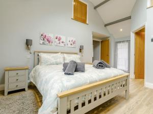 a bedroom with a large bed with towels on it at Cwm Dulas in Llanddewi-Brefi