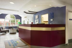 a lobby with a reception desk in a building at Microtel Inn By Wyndham Louisville East in Louisville