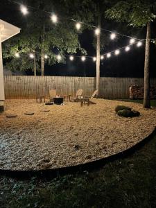 a backyard at night with a table and chairs at R Dawg House Walking distance to Everything Athens in Athens