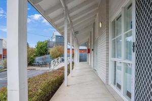 a walkway outside of a building with a porch at Mibnb Geelong CBD in Geelong