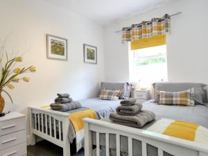two twin beds in a bedroom with towels at No 2 Railway Cuttings - Uk3402 in Falstone