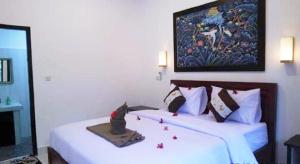 a hotel room with two beds with red confederaciesemetery at Padanta Gili Trawangan in Gili Trawangan +10 photos