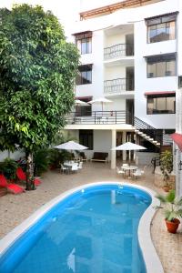 a swimming pool in front of a building at Hotel Jose Antonios Inn in Puerto Maldonado