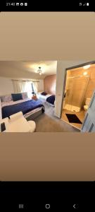a room with two beds and a tv in it at Ardhill House B&B The Diamond, in the Heart of Ardara Town , F94 C7X9 in Ardara