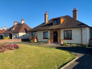 a house with a lawn in front of it at Kinvara in Stranraer