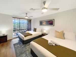 a hotel room with two beds and a window at Nottage Cottage in Branxton +12 photos