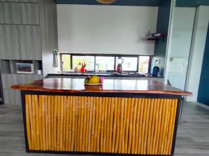 a kitchen with a counter with a bowl of fruit on it at Nha Bong Villa in Hoi An
