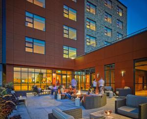 people sitting on a patio in front of a building at Hotel Vermont Burlington in Burlington