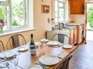 a kitchen with a table with a bottle of wine at Valley View in Upper Arley