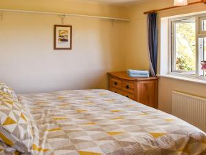 a bedroom with a large bed and a window at Valley View in Upper Arley