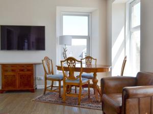 a dining room with a table and chairs at Inver House Apartment in Inverurie