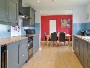 a kitchen with a table and a dining room at Greentops in Blackwood