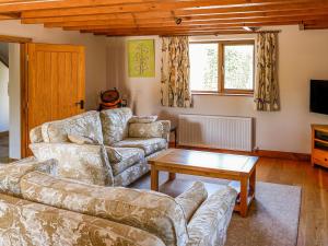 a living room with a couch and a table at The Milking Parlour in Tutbury