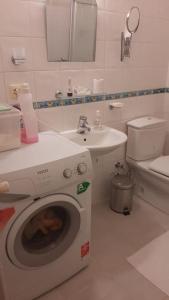 a bathroom with a washing machine and a sink at Escape to Bird's Nest in Buyukada in Adalar