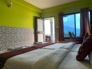 A bed or beds in a room at Lake Vision Guesthouse