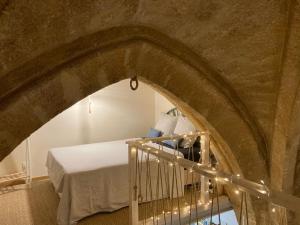 a room with a bed and a staircase with lights at L'Aiguillerie in Montpellier