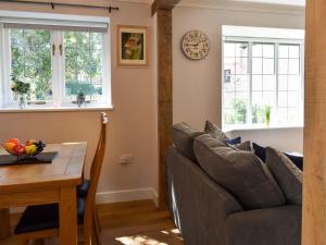 a living room with a couch and a table at Ty Draw in Rhuddlan