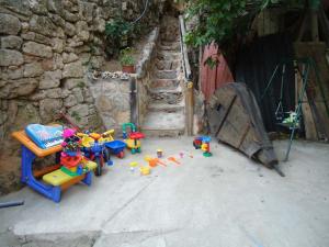 a group of toys sitting on the ground next to a building at El Salto del Agua Auténtico El Molino de la Cascada Orbaneja in Orbaneja del Castillo