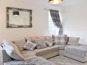 a living room with a couch and a mirror at The Mouse Hole - UK36100 in Amlwch