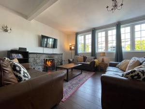 a living room with two couches and a fireplace at Seafield Lodge in Grantown on Spey