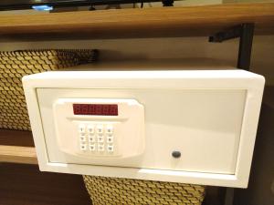 a microwave oven on a shelf in a room at Acro Residences in Guiguinto