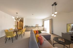 a living room with a couch and a dining room at Hotel Hennersberg in Wörgl